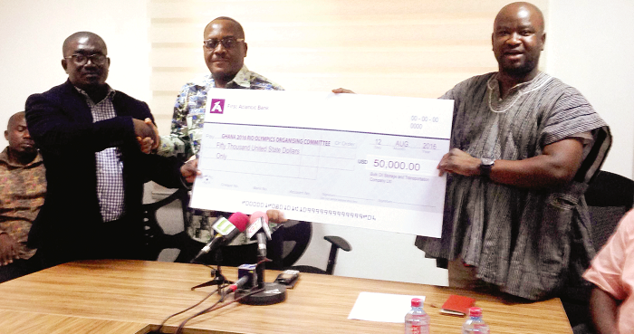 The Public Relations Officer of BOST, Mr Salifu Nat Acheampong (right), presenting the dummy cheque to the Chief Director of the Ministry of Youth and Sports, Victor Xola Senaya (middle). The Public Relations Officer of BOST, Mr Salifu Nat Acheampong (right), presenting the dummy cheque to the Chief Director of the Ministry of Youth and Sports, Victor Xola Senaya (middle).